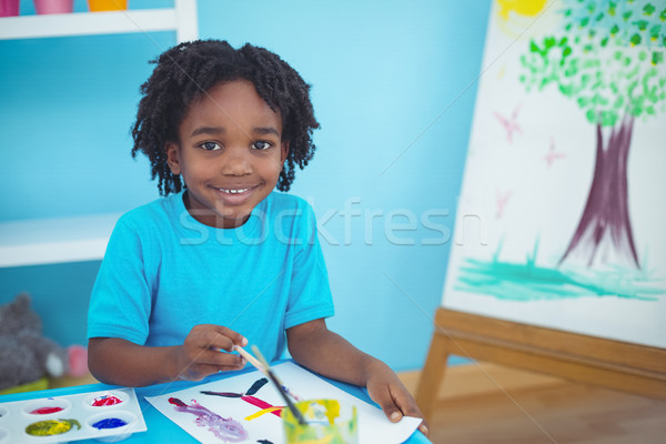 Happy kid enjoying arts and crafts painting Stock photo © wavebreak_media