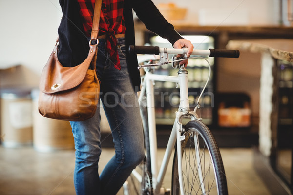 Mid section of woman standing along with bicycle Stock photo © wavebreak_media
