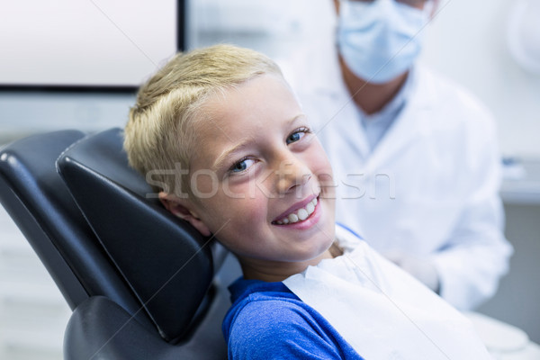 Smiling young patient sitting on dentist chair Stock photo © wavebreak_media
