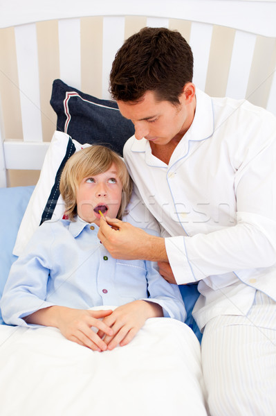 Worried father checking his son's temperature Stock photo © wavebreak_media