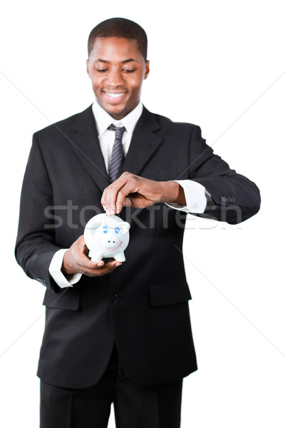 Businessman putting money in his piggy bank  Stock photo © wavebreak_media