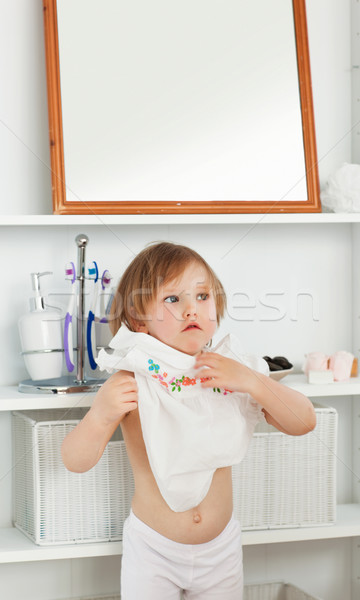 Small girl changing clothes in bathroom Stock photo © wavebreak_media