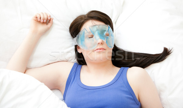 Caucasian young woman sleeping with an eye mask lying on a bed Stock photo © wavebreak_media