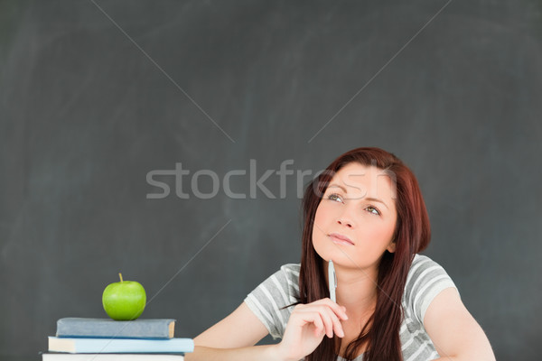 Pensive young student writting an essay in a classroom Stock photo © wavebreak_media