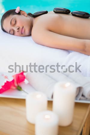 dark-haired woman with rose lying on bed in bedroom Stock photo © wavebreak_media