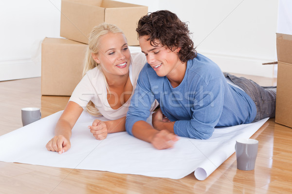 Couple moving in a new house lying on the floor Stock photo © wavebreak_media