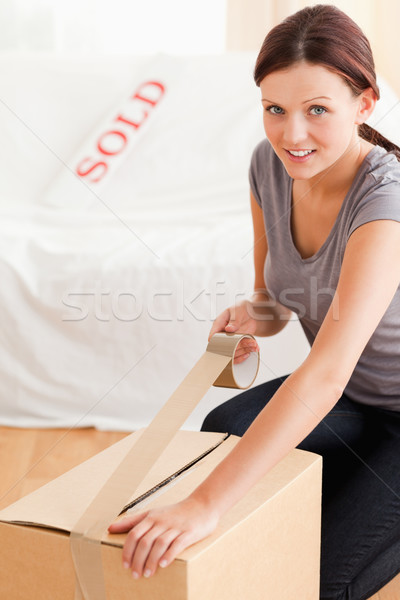 A female is preparing a cardboard for the transport Stock photo © wavebreak_media