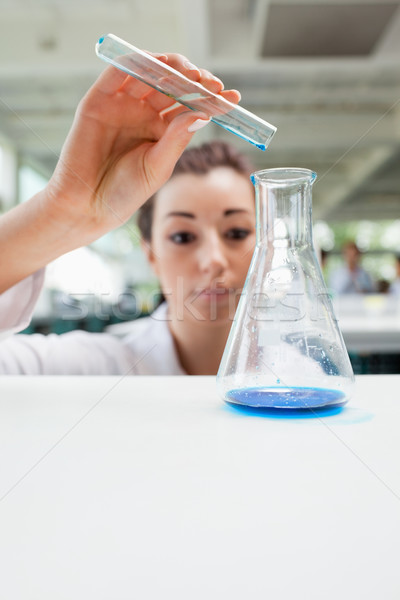 Portrait of a serious science student pouring liquid in a laboratory Stock photo © wavebreak_media