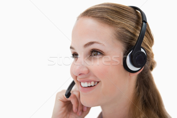 Stock photo: Side view of smiling call center agent against a white background