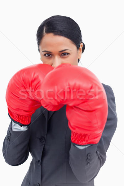 Close up of belligerent saleswoman with boxing gloves against a white background Stock photo © wavebreak_media