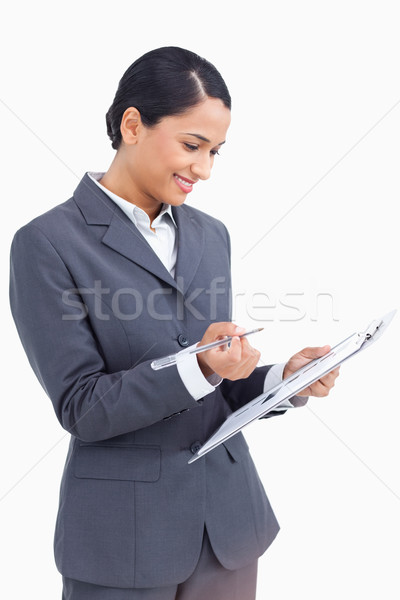 Close up of saleswoman with clipboard and pen against a white background Stock photo © wavebreak_media