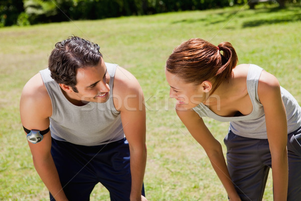 Man and a woman bending over as they recover while looking at each other Stock photo © wavebreak_media