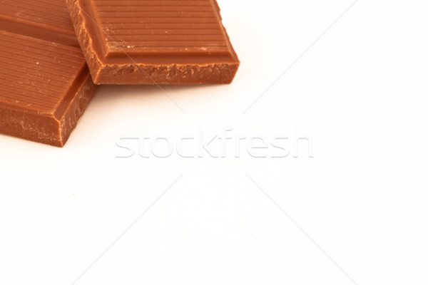 Two pieces of milk chocolate against a white background  Stock photo © wavebreak_media