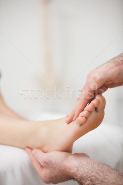 Doctor offering a foot massage in a medical room Stock photo © wavebreak_media