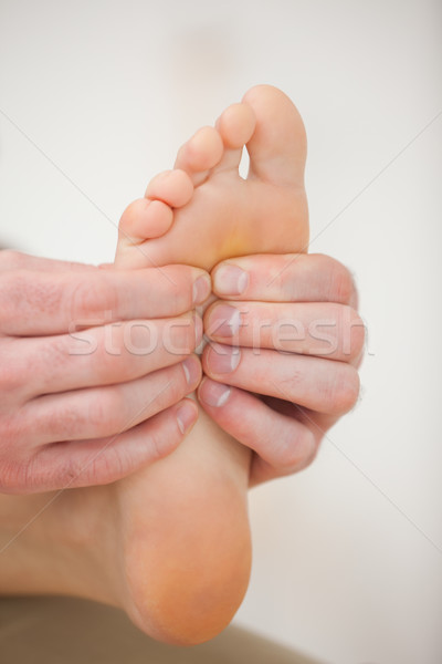 Barefoot being massaged by a physiotherapist in a room Stock photo © wavebreak_media