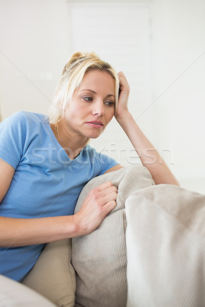 Stock photo: Worried young woman sitting in living room