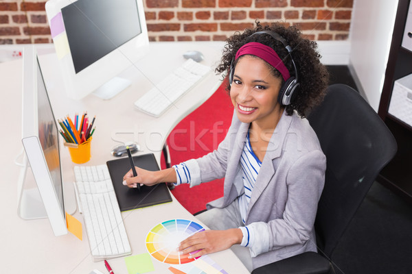 Stock photo: Female photo editor using digitizer in office