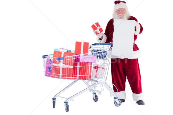 Santa spread presents with shopping cart Stock photo © wavebreak_media