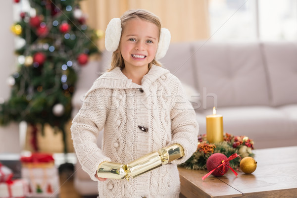 Festive little girl holding a cracker Stock photo © wavebreak_media