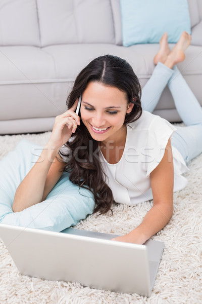 Pretty brunette using her laptop Stock photo © wavebreak_media