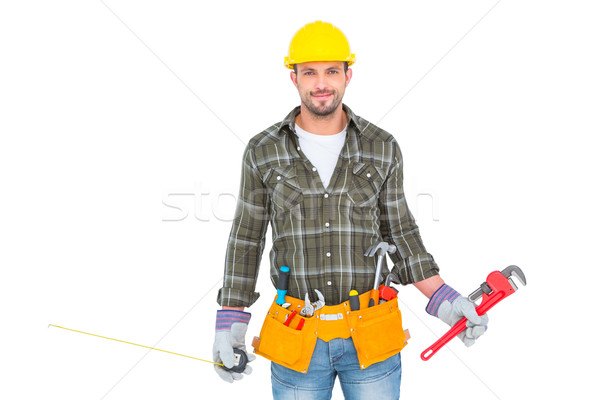 Stock photo: Manual worker holding various tools 
