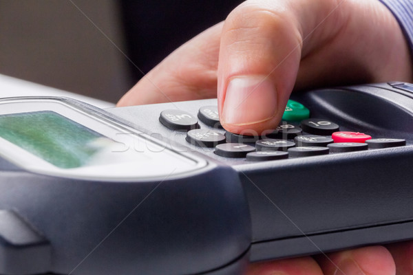 Man entering his pin on terminal Stock photo © wavebreak_media