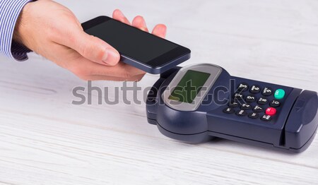 Stock photo: Man using smartphone to express pay 