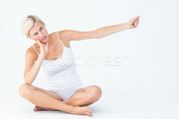 Upset woman sitting on the floor raising her arm  Stock photo © wavebreak_media