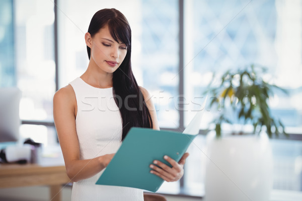 Attentive executive reading file Stock photo © wavebreak_media