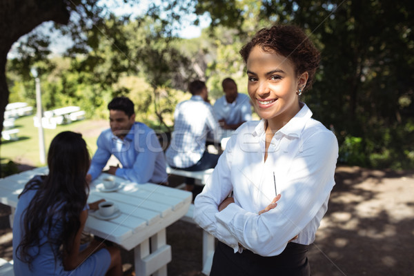 Waitress standing with arms crossed at outdoor restaurant Stock photo © wavebreak_media