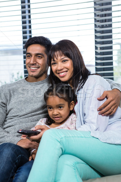 Souriant famille regarder tv canapé salon [[stock_photo]] © wavebreak_media