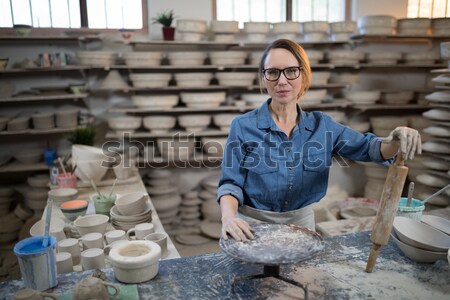 Portrait of female potter standing with mobile phone Stock photo © wavebreak_media