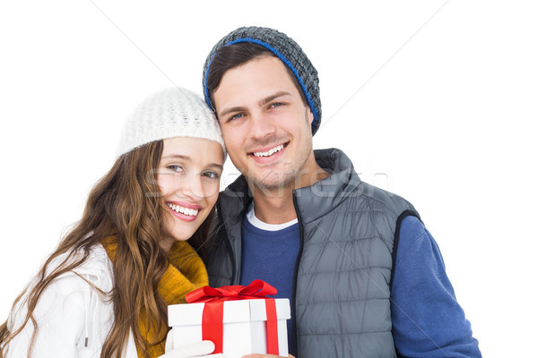 Happy couple holding gift box together Stock photo © wavebreak_media