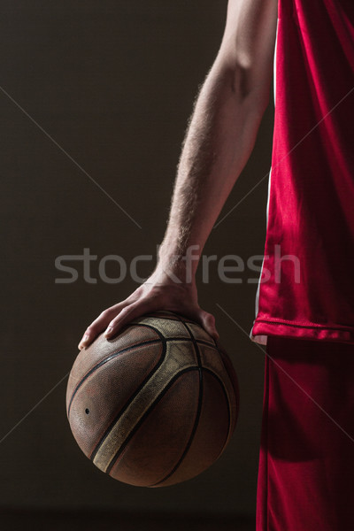Close up on basketball held by basketball player Stock photo © wavebreak_media