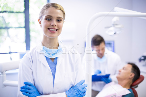 Portrait of smiling dentist standing  with arms crossed Stock photo © wavebreak_media