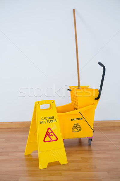 Sigh boad with mop bucket against wall Stock photo © wavebreak_media