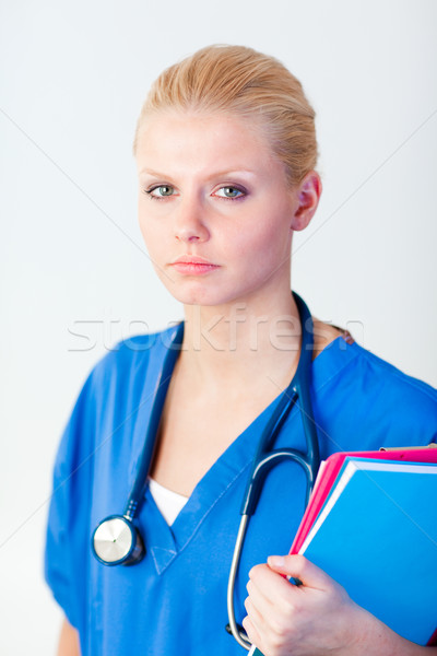 Stock photo: Young female doctor holding a folder