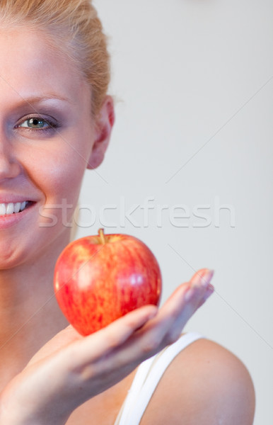 Stock photo: Close-up of an attractive woman holding apple with focus on woman