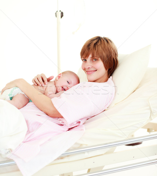 Patient with newborn baby in bed smiling at the camera Stock photo © wavebreak_media