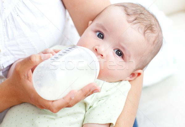 Charming mother feeding her adorable son in the kitchen at home Stock photo © wavebreak_media