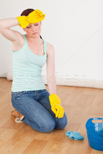 Attractive red-haired woman having a break while cleaning the floor at home Stock photo © wavebreak_media
