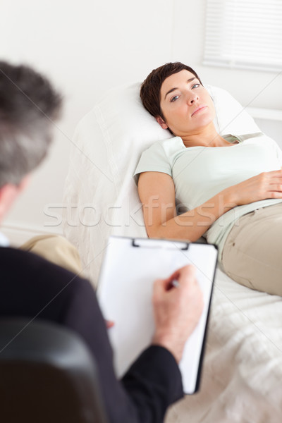 Psychologist talking to a sad female patient in a room Stock photo © wavebreak_media