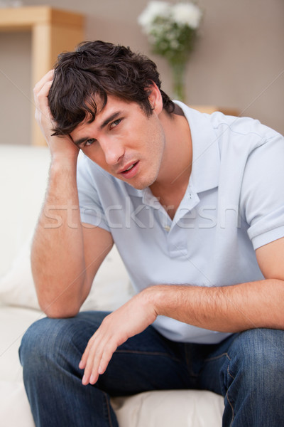 Despaired young man sitting on the couch Stock photo © wavebreak_media