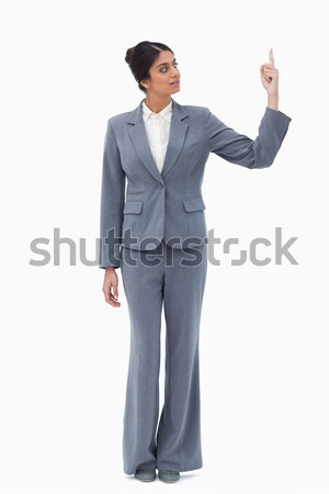 Saleswoman pointing up against a white background Stock photo © wavebreak_media