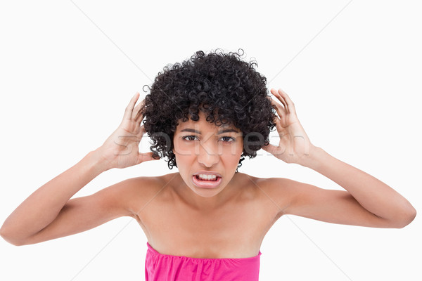 Upset teenage placing her hands beside her ears because of the noise Stock photo © wavebreak_media