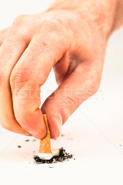 Hand extinguished a cigarette against a white background Stock photo © wavebreak_media