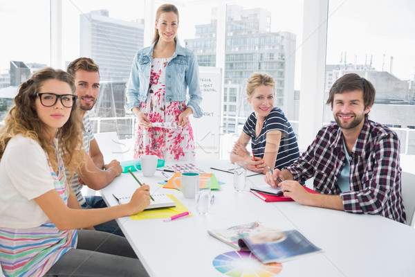 Casual business people around conference table in office Stock photo © wavebreak_media