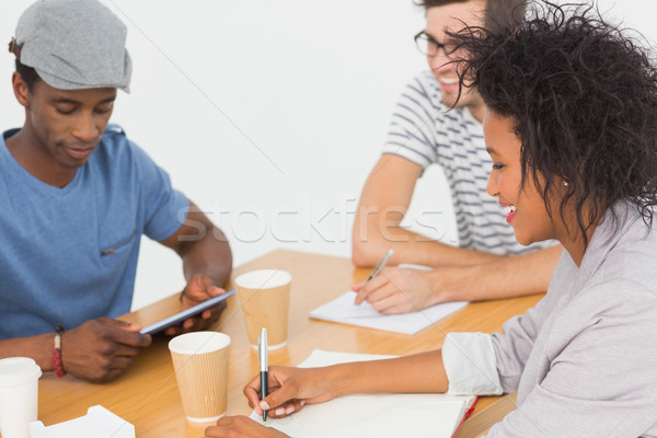 Group of happy artists in discussion at desk Stock photo © wavebreak_media