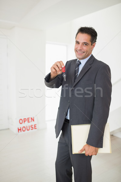 Businessman with documents holding up keys Stock photo © wavebreak_media