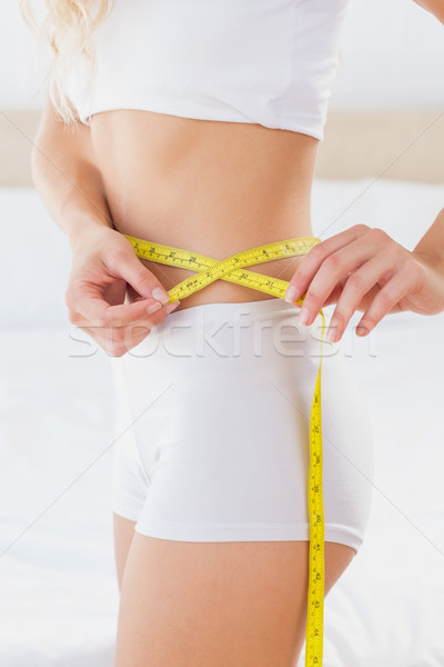 Toned woman measuring her waist Stock photo © wavebreak_media